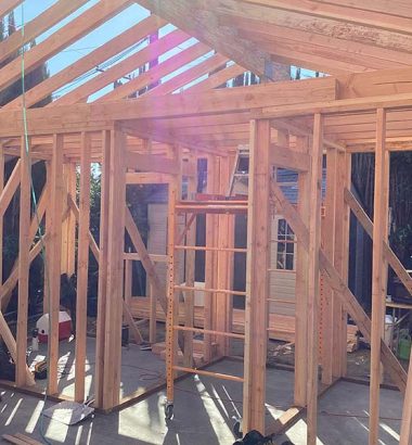 A room featuring exposed wood framing and structural elements, showcasing the construction details and design.