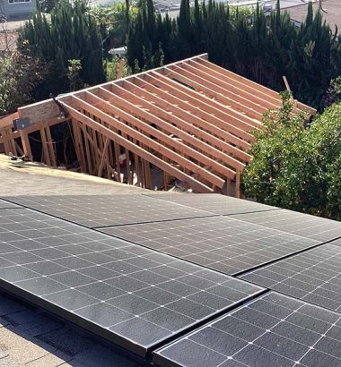 Solar panels installed on the roof of a house, showcasing renewable energy technology in a residential setting.