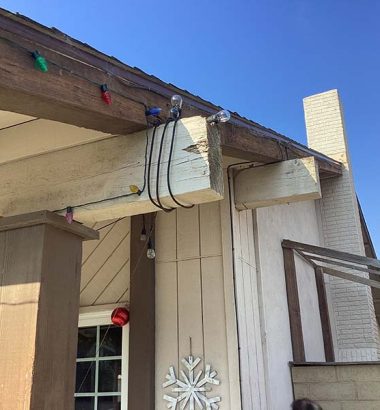 A house adorned with colorful Christmas lights illuminating the roof, creating a festive holiday atmosphere.