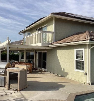 A house featuring a grill and a swimming pool in the backyard, ideal for outdoor gatherings and relaxation.